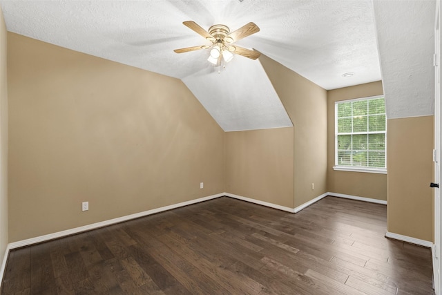 3602 Blue Lake Dr, Spring, TX 77388 - additional living space with dark wood-type flooring, ceiling fan, a textured ceiling, baseboards, and vaulted ceiling