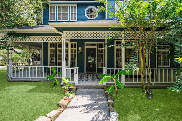 2474 Ripplewood Ct, Conroe, TX 77384 - entrance to property with covered porch and a lawn