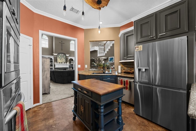 2474 Ripplewood Ct, Conroe, TX 77384 - kitchen featuring stainless steel appliances, a sink, concrete floors, ornamental molding, and wooden counters
