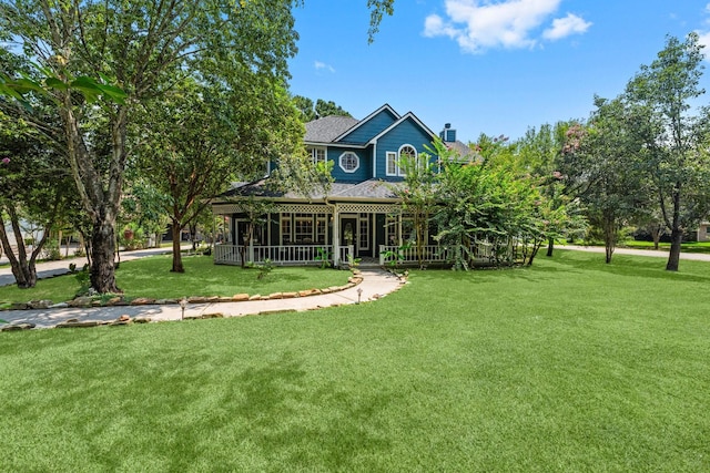2474 Ripplewood Ct, Conroe, TX 77384 - view of front facade with a chimney, a front lawn, and a shingled roof