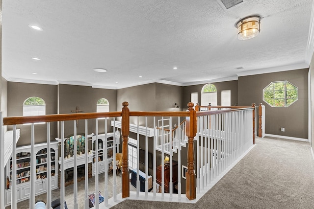 2474 Ripplewood Ct, Conroe, TX 77384 - hallway with carpet, baseboards, a textured ceiling, recessed lighting, and ornamental molding
