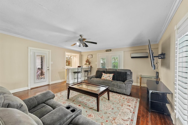 4522 Geneva Dr, Houston, TX 77066 - living room with a wall mounted AC, dark wood-style floors, a ceiling fan, baseboards, and crown molding