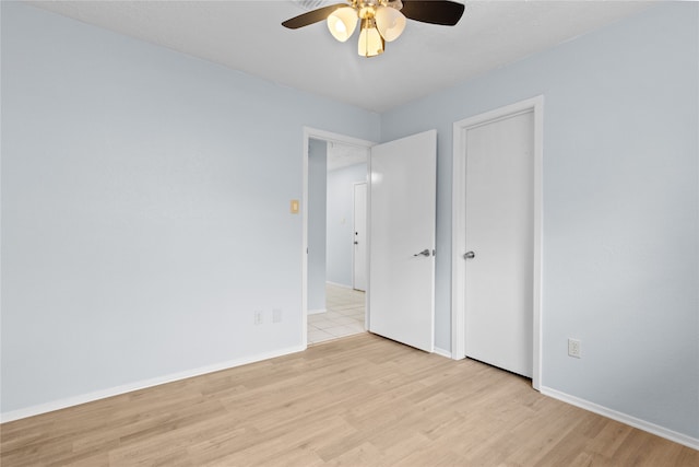 11818 Guadalupe River Dr, Houston, TX 77067 - unfurnished bedroom featuring light wood-style floors, baseboards, and a ceiling fan