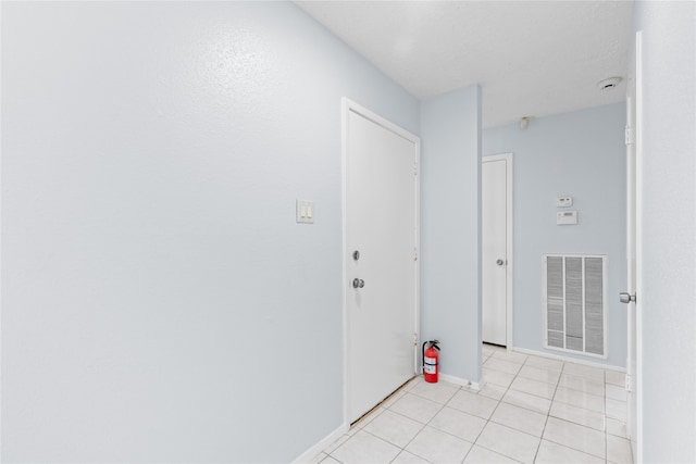 11818 Guadalupe River Dr, Houston, TX 77067 - hallway with baseboards and light tile patterned floors