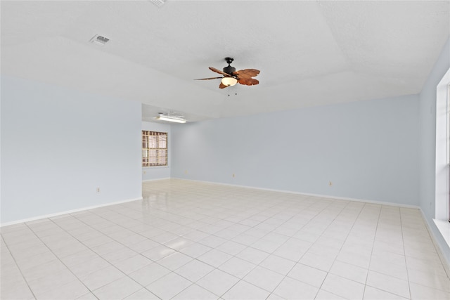 11818 Guadalupe River Dr, Houston, TX 77067 - empty room featuring ceiling fan, baseboards, light tile patterned floors, and a textured ceiling