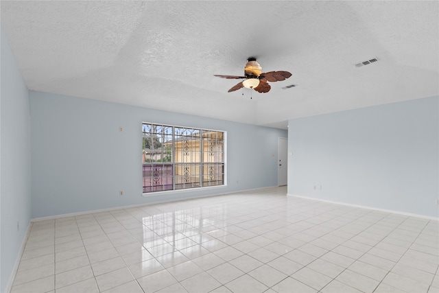 11818 Guadalupe River Dr, Houston, TX 77067 - spare room with a ceiling fan, a textured ceiling, light tile patterned floors, and baseboards