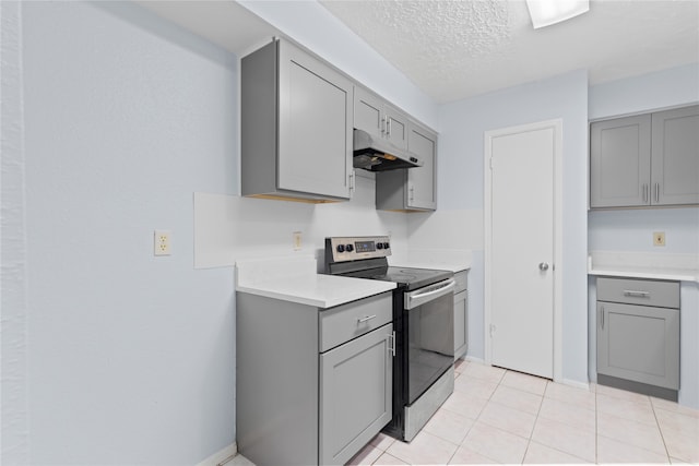 11818 Guadalupe River Dr, Houston, TX 77067 - kitchen with gray cabinets, stainless steel electric stove, under cabinet range hood, light countertops, and a textured ceiling