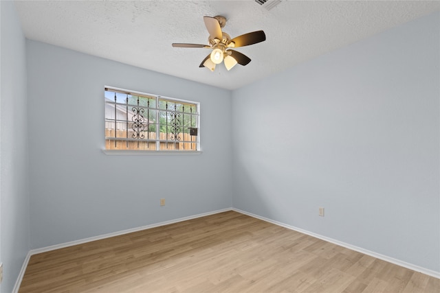 11818 Guadalupe River Dr, Houston, TX 77067 - spare room with wood finished floors, a textured ceiling, baseboards, and a ceiling fan