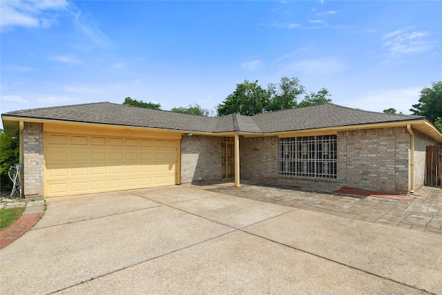 11818 Guadalupe River Dr, Houston, TX 77067 - view of front of property featuring concrete driveway, an attached garage, brick siding, and roof with shingles