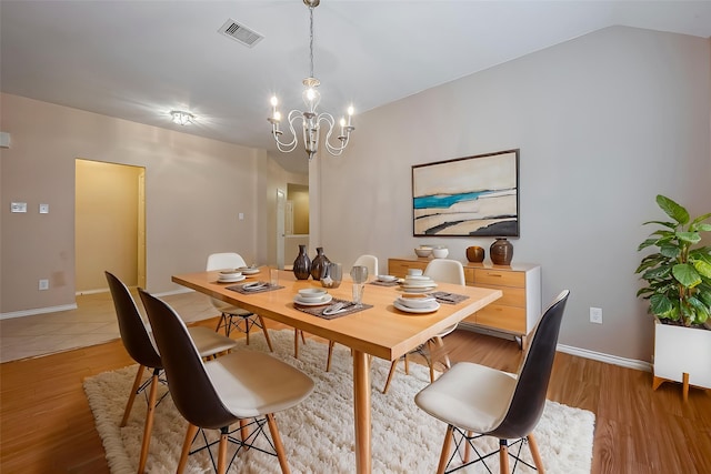 16715 Red Falls Cir, Houston, TX 77095 - dining room with a chandelier, light wood-type flooring, baseboards, and lofted ceiling