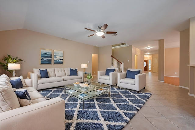 16715 Red Falls Cir, Houston, TX 77095 - living area featuring light tile patterned floors, a ceiling fan, stairs, baseboards, and vaulted ceiling