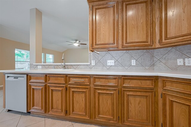 16715 Red Falls Cir, Houston, TX 77095 - kitchen with dishwasher, brown cabinets, a ceiling fan, and vaulted ceiling