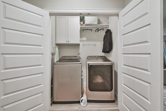 2818 Grand Fountains Dr Unit C, Houston, TX 77054 - laundry area with washing machine and dryer, cabinet space, and light wood finished floors