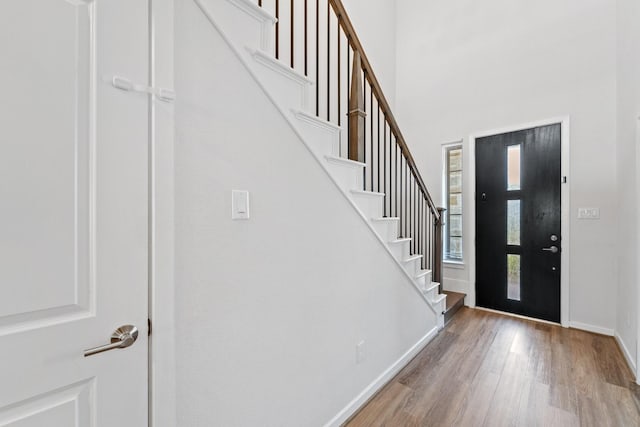 5411 Cavall Rd, Missouri City, TX 77459 - entrance foyer with wood finished floors, baseboards, stairs, and a towering ceiling