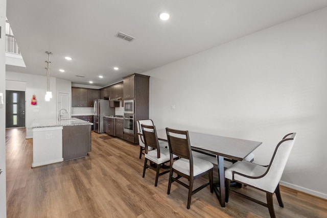 5411 Cavall Rd, Missouri City, TX 77459 - dining space with wood finished floors, recessed lighting, and baseboards