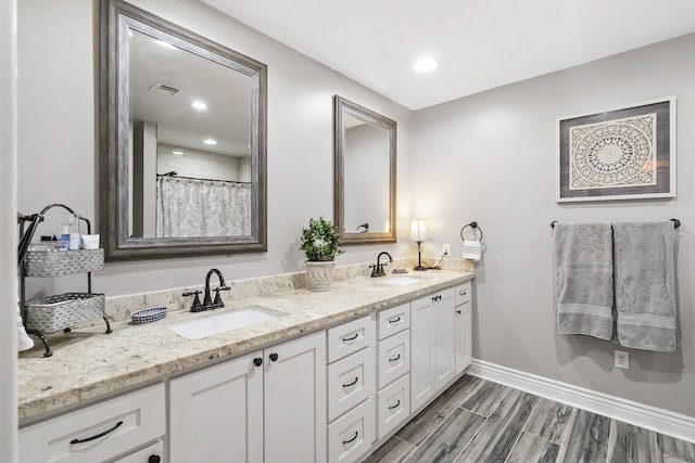 15726 Steamboat Ln, Houston, TX 77079 - full bath with double vanity, baseboards, recessed lighting, and wood finished floors