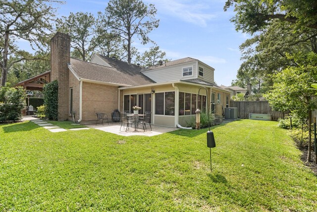 15726 Steamboat Ln, Houston, TX 77079 - back of property featuring central air condition unit, a patio area, a chimney, a sunroom, and roof with shingles