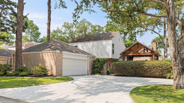 15726 Steamboat Ln, Houston, TX 77079 - view of front facade featuring a garage, brick siding, and driveway