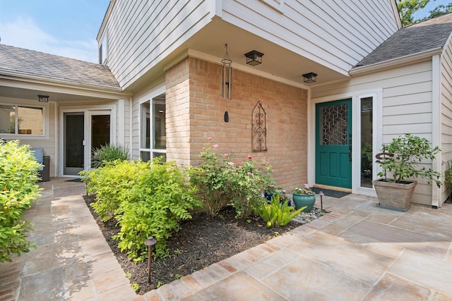 15726 Steamboat Ln, Houston, TX 77079 - doorway to property featuring brick siding and a shingled roof