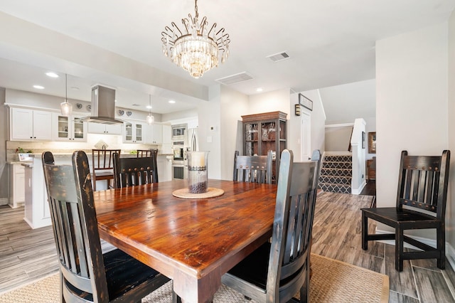 15726 Steamboat Ln, Houston, TX 77079 - dining space featuring a chandelier, light wood-style floors, recessed lighting, and baseboards