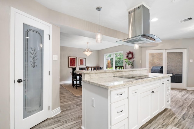 15726 Steamboat Ln, Houston, TX 77079 - kitchen with exhaust hood, baseboards, black electric stovetop, and white cabinets