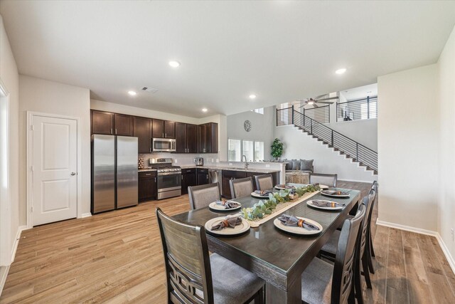 1523 Alpine Dr, Rosharon, TX 77583 - dining space featuring light wood finished floors, baseboards, stairway, recessed lighting, and a ceiling fan