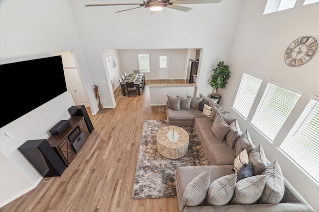 1523 Alpine Dr, Rosharon, TX 77583 - living area with a towering ceiling, ceiling fan, light wood-type flooring, and baseboards