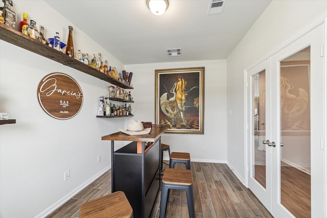 1523 Alpine Dr, Rosharon, TX 77583 - home office with french doors, wood finished floors, baseboards, and a dry bar