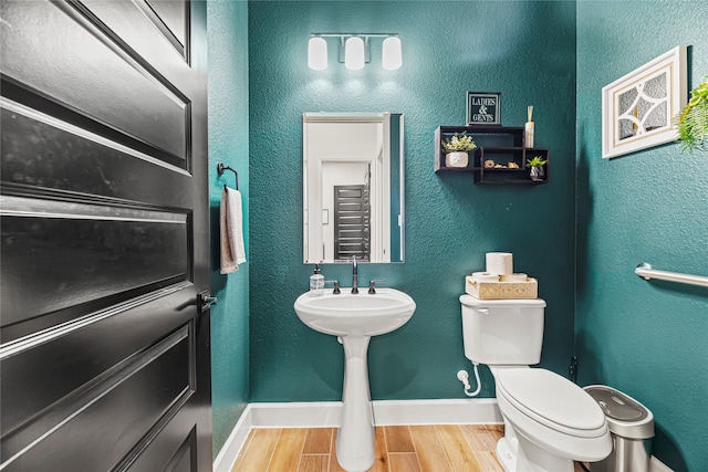 21511 Blue Porterweed Trl, Cypress, TX 77433 - bathroom with wood finished floors and a textured wall