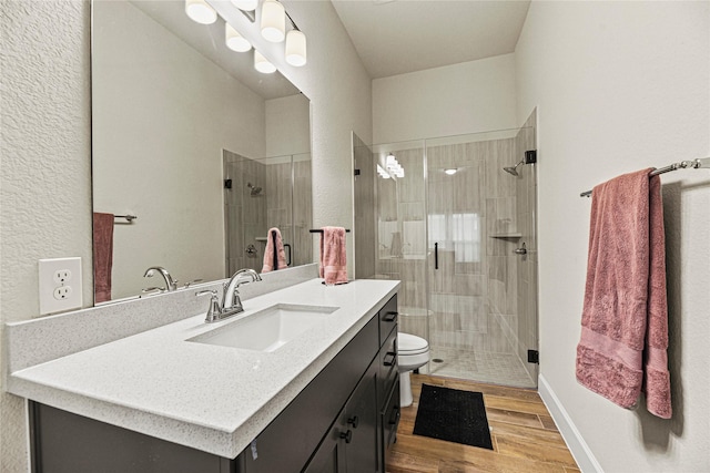 21511 Blue Porterweed Trl, Cypress, TX 77433 - bathroom with toilet, wood finished floors, a stall shower, and vanity
