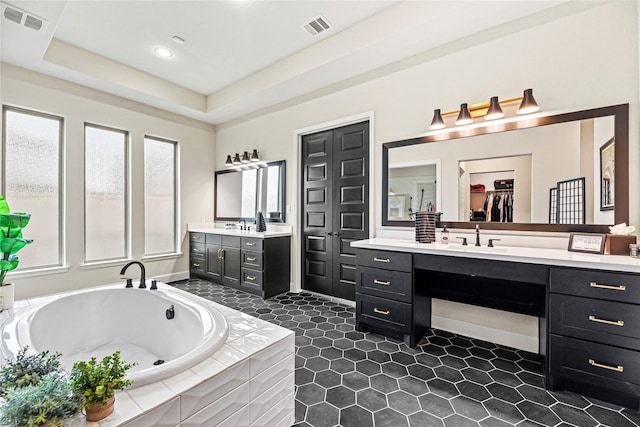 21511 Blue Porterweed Trl, Cypress, TX 77433 - full bath featuring two vanities, a garden tub, tile patterned flooring, recessed lighting, and a walk in closet
