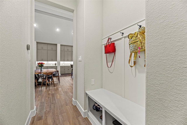 21511 Blue Porterweed Trl, Cypress, TX 77433 - mudroom featuring a textured wall, wood finished floors, and baseboards
