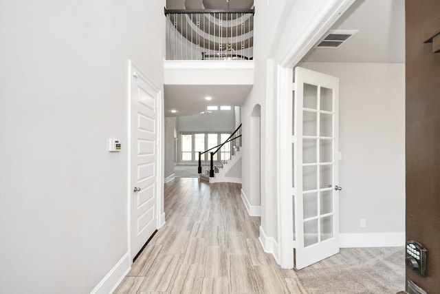 30702 Barred Owl Way, Brookshire, TX 77423 - entrance foyer with stairs, arched walkways, baseboards, wood finished floors, and a high ceiling