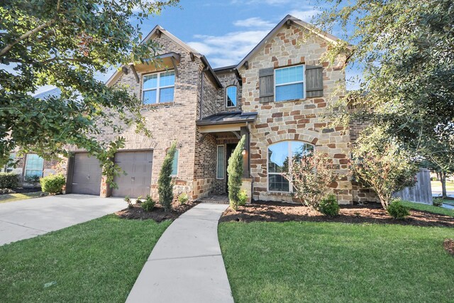 30702 Barred Owl Way, Brookshire, TX 77423 - view of front of property with a front lawn, driveway, brick siding, and stone siding