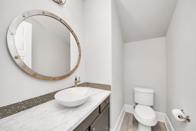 30702 Barred Owl Way, Brookshire, TX 77423 - half bath with toilet, vanity, wood finished floors, baseboards, and vaulted ceiling
