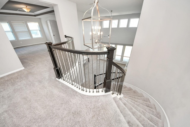 30702 Barred Owl Way, Brookshire, TX 77423 - stairs featuring a chandelier, carpet, baseboards, and a raised ceiling