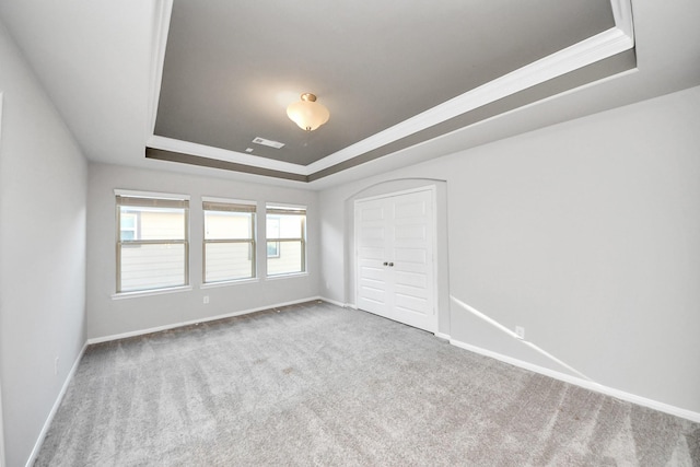 30702 Barred Owl Way, Brookshire, TX 77423 - unfurnished bedroom featuring a raised ceiling, carpet flooring, baseboards, crown molding, and a closet