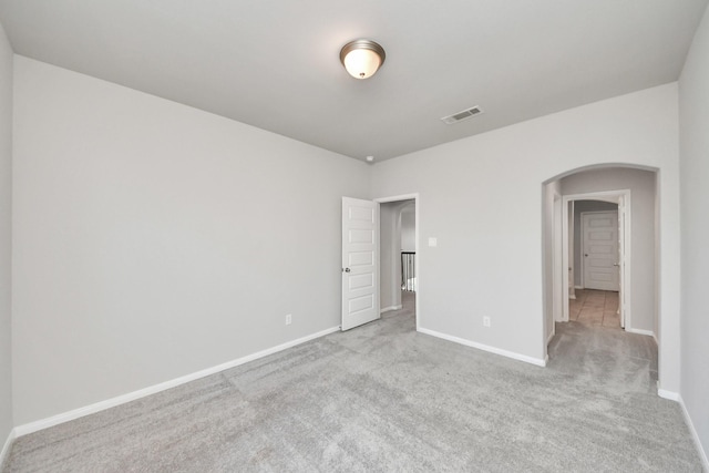 30702 Barred Owl Way, Brookshire, TX 77423 - unfurnished room with arched walkways, carpet floors, and baseboards