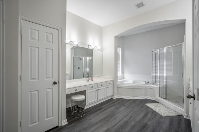 10522 Kirkwell Manor Ct, Spring, TX 77379 - bathroom featuring vanity, a shower stall, a bath, and wood finished floors