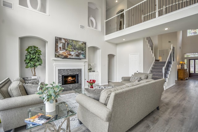 10522 Kirkwell Manor Ct, Spring, TX 77379 - living area featuring a high ceiling, a fireplace, wood finished floors, baseboards, and stairway