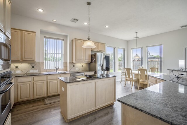10522 Kirkwell Manor Ct, Spring, TX 77379 - kitchen with light brown cabinets, appliances with stainless steel finishes, a sink, a center island, and recessed lighting