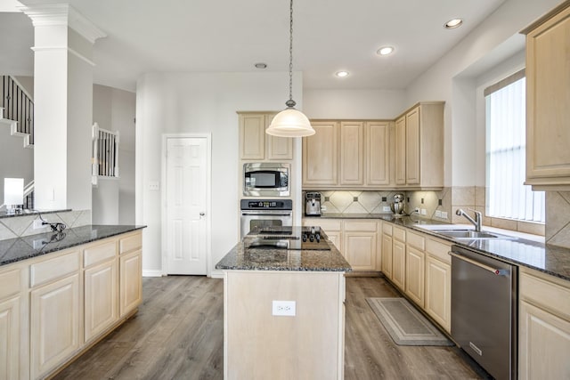 10522 Kirkwell Manor Ct, Spring, TX 77379 - kitchen featuring stainless steel appliances, light brown cabinetry, a sink, wood finished floors, and dark stone counters