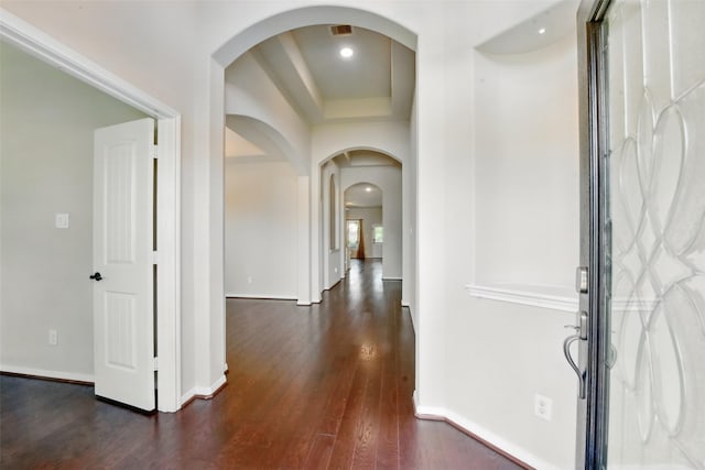 22907 Caverly Ln, Tomball, TX 77375 - entrance foyer with dark wood-type flooring, arched walkways, baseboards, a raised ceiling, and recessed lighting