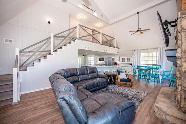 1981 County Road 291, Sargent, TX 77414 - living area with high vaulted ceiling, wood finished floors, stairway, and a ceiling fan