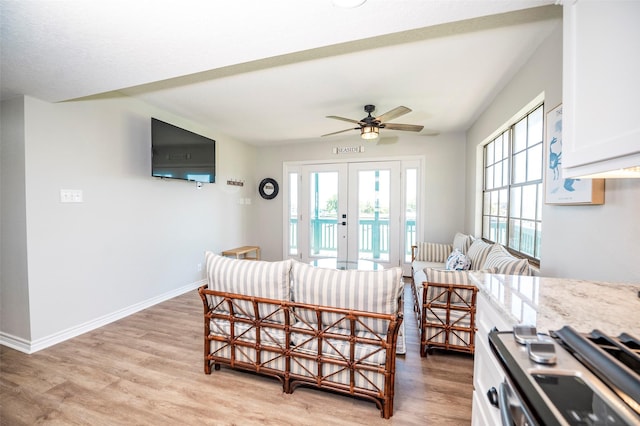 1981 County Road 291, Sargent, TX 77414 - living area with french doors, healthy amount of natural light, light wood finished floors, and a ceiling fan