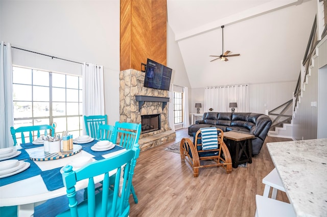 1981 County Road 291, Sargent, TX 77414 - living area with high vaulted ceiling, a ceiling fan, light wood finished floors, stairway, and a stone fireplace