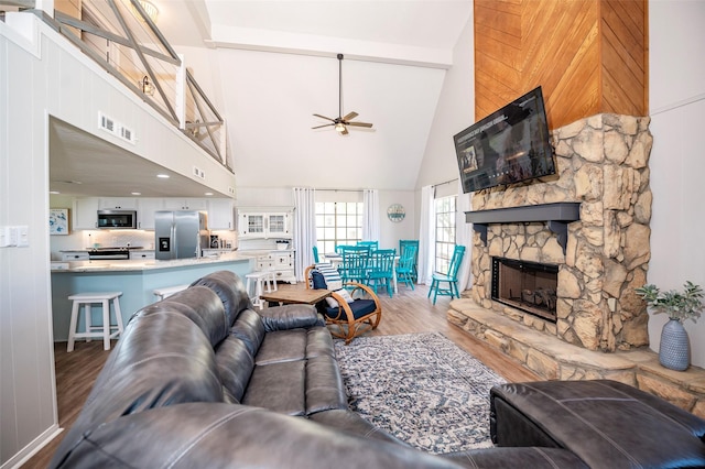1981 County Road 291, Sargent, TX 77414 - living room with high vaulted ceiling, ceiling fan, wood finished floors, beam ceiling, and a fireplace