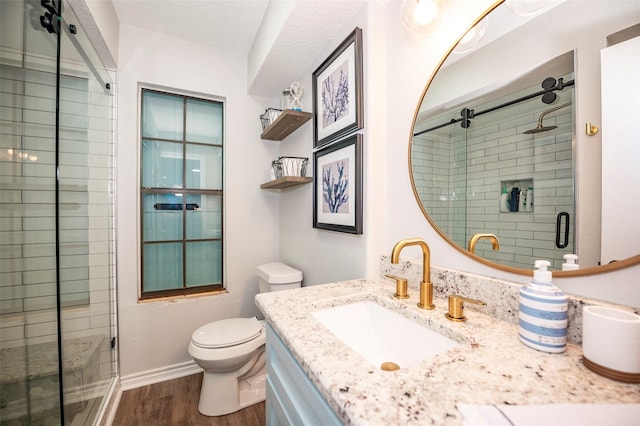 1981 County Road 291, Sargent, TX 77414 - full bathroom with wood finished floors, a shower stall, toilet, vanity, and baseboards