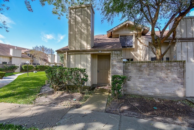 3206 Windchase Blvd Unit 471, Houston, TX 77082 - view of front of home with a chimney and a residential view