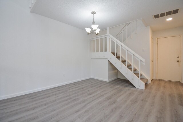 3206 Windchase Blvd Unit 471, Houston, TX 77082 - unfurnished living room with wood finished floors, stairs, a chandelier, baseboards, and recessed lighting